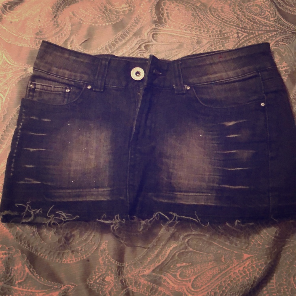Black denim skirt with studded accents.